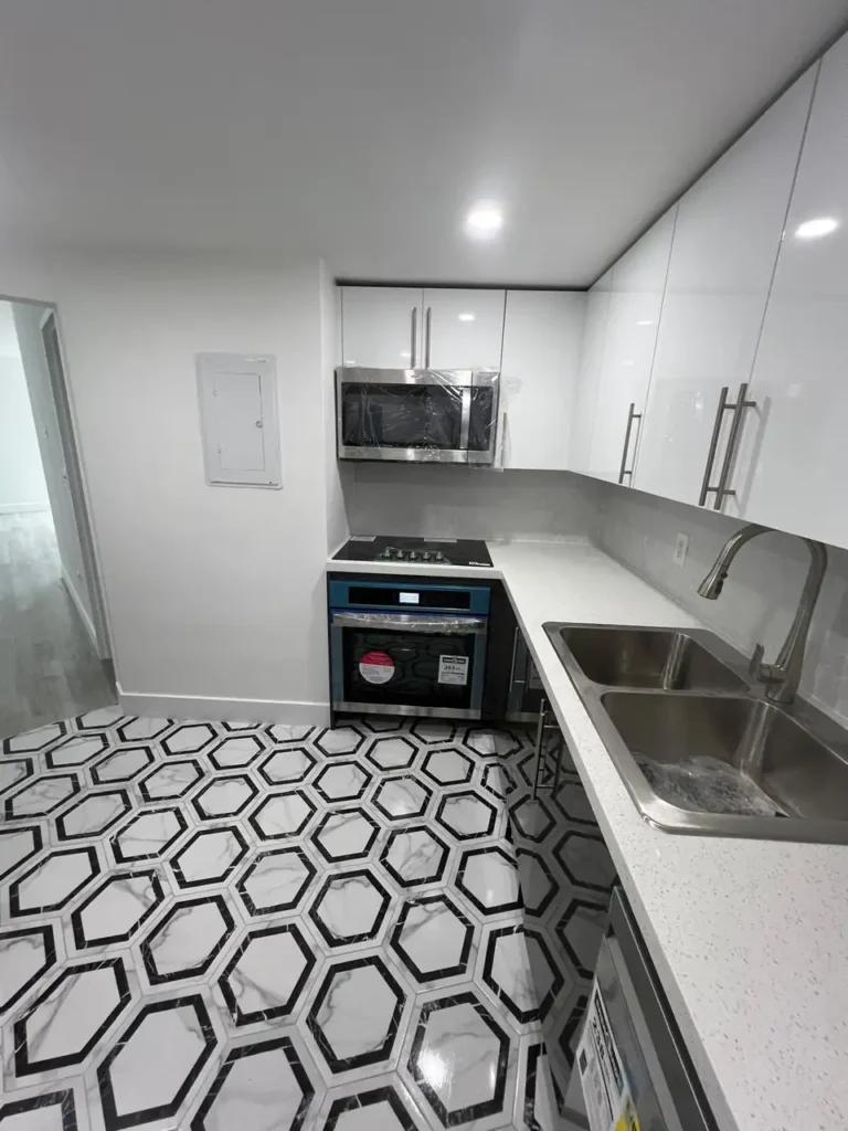 Wide view of the finished bathroom, showing the harmony between the tiling, fixtures, and lighting.